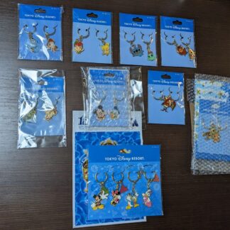 Key rings and pins set with figures and books